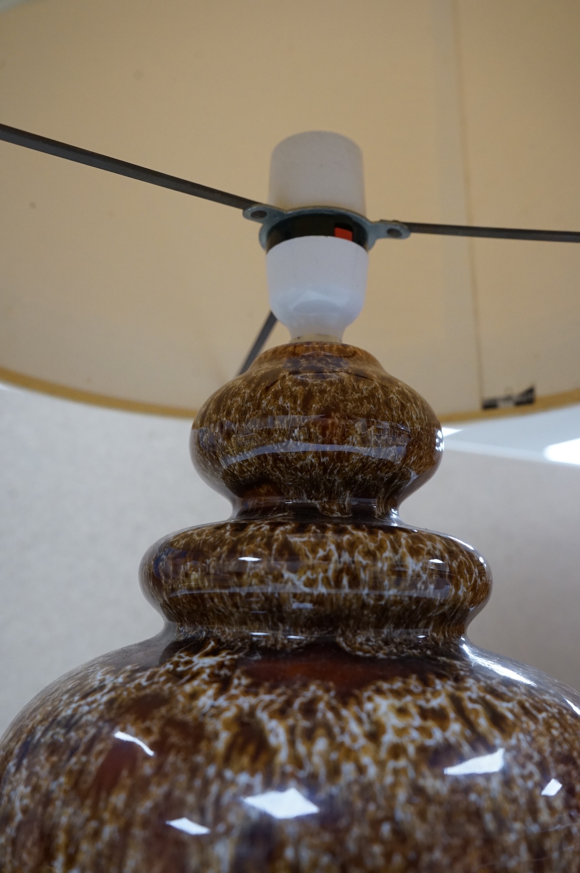 A mid century modern brown glazed ceramic table lamp and brown braided shade, 84cm including shade